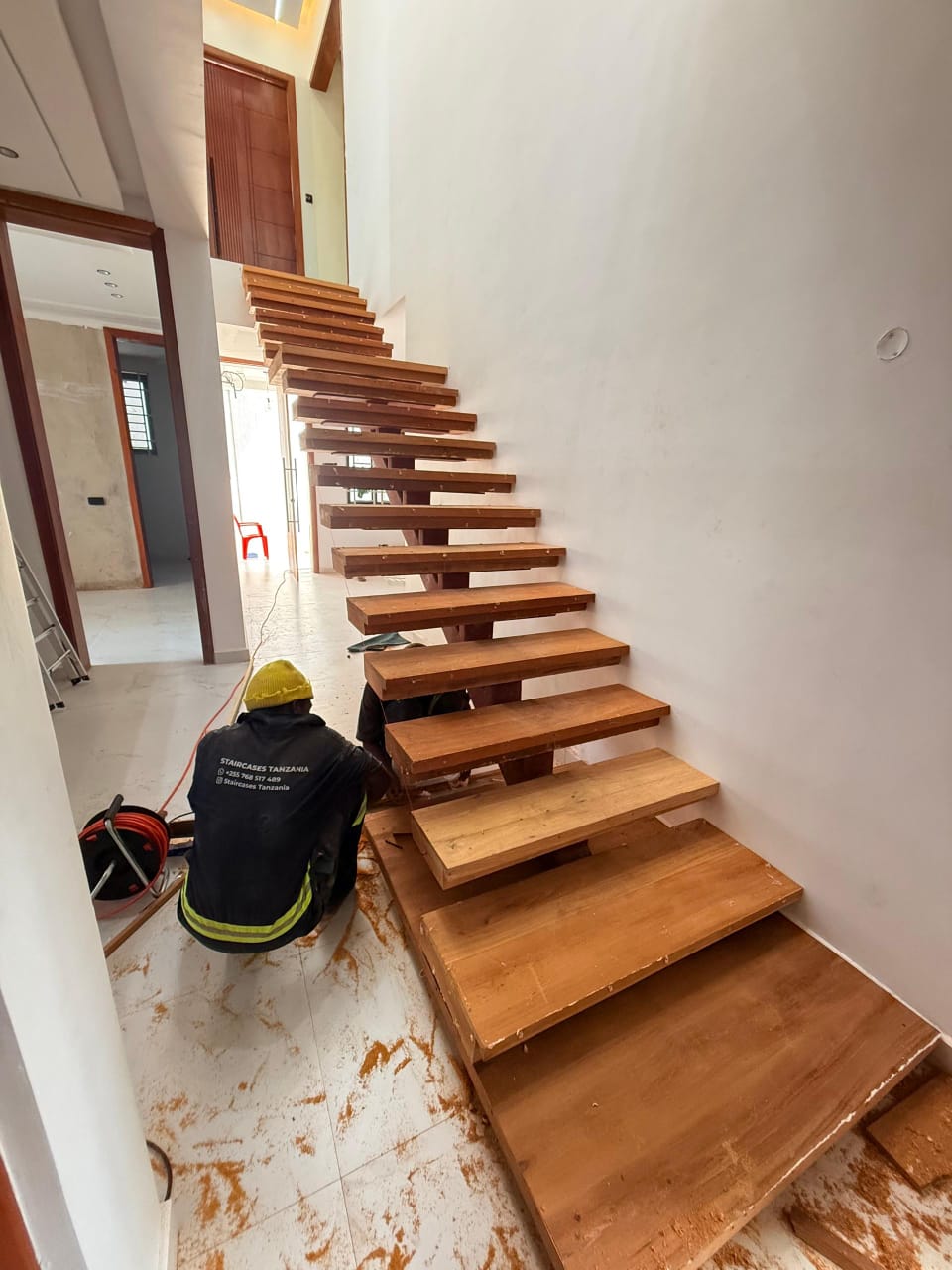 Staircases Tanzania master craftsmen fitting structural balustrade hardware on site
